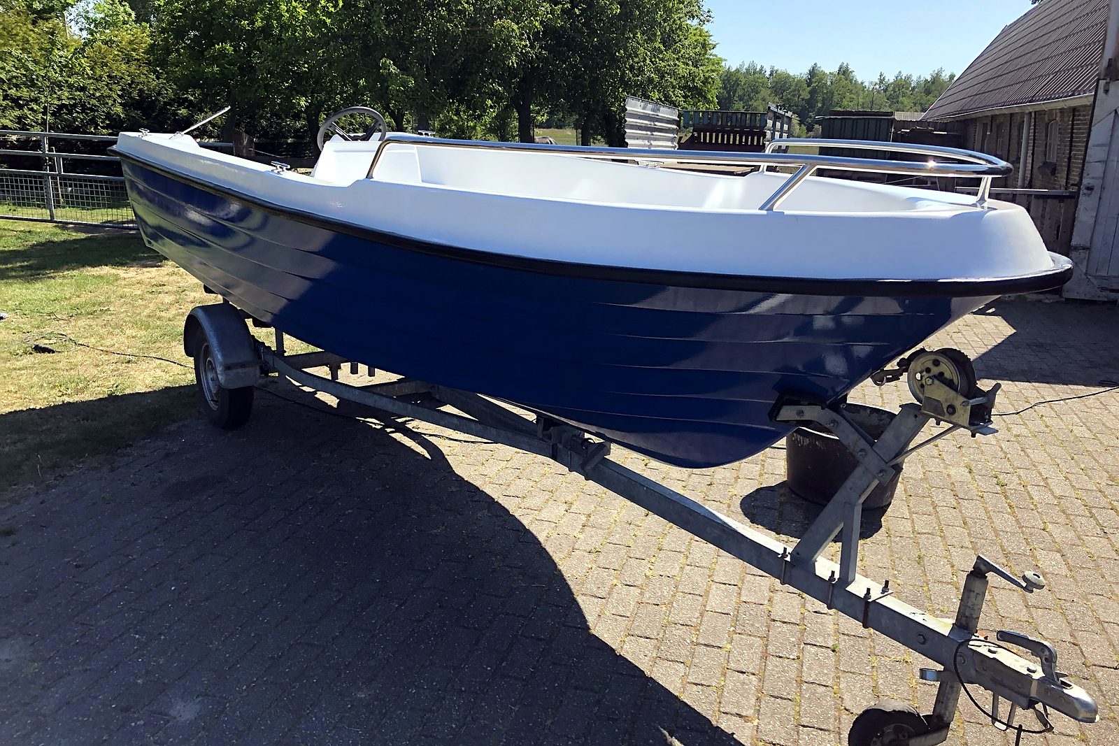 Blue sloop with railing, side view